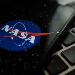 NASA logo on smartphone resting on a laptop keyboard