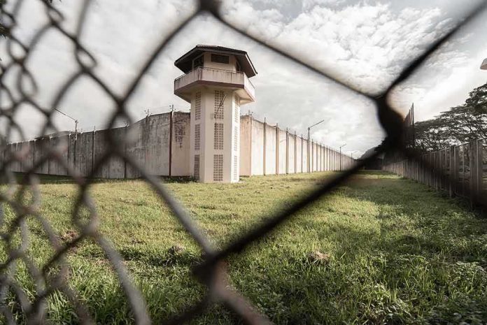 Prison watchtower behind chain-link fence