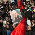 Qasem Soleimani posters held in a large crowd; Kate Beaton present among attendees