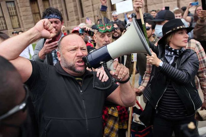shutterstock_1712289367 Gerald Jones speaks through a megaphone at a crowded outdoor protest