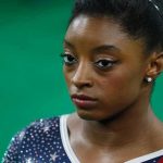 Biles Vs. Gaines Explodes — Policy Debate Becomes Personal Conflict Simone Biles in close-up wearing a sparkly gymnastics leotard