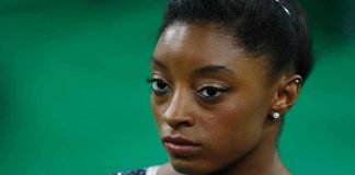 Simone Biles in close-up wearing a sparkly gymnastics leotard