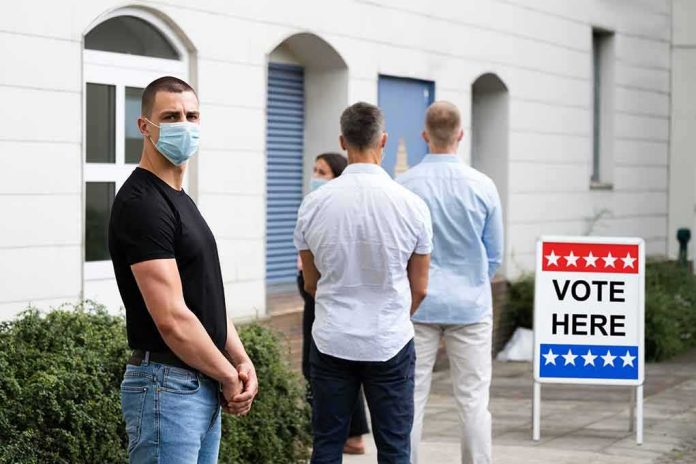 shutterstock_1772910047 People wearing masks standing in line outside a polling place
