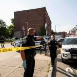 Mob-Tied Councilman Cuffed Again Police officers secure an urban street with yellow tape near patrol cars