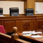 Judge Says Roll Cameras empty courtroom with judge's bench and microphones