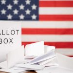 Trump Loyalty CRUSHES Cassidy in Louisiana Ballot box with papers in front of an American flag