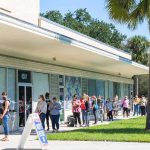 Youth Revolt Upends Dem Power Map People lined up outside a building to vote