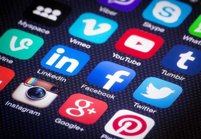 shutterstock_186292982 smartphone screen with social media app icons