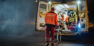 Vegas Icon Rushed To Hospital Paramedics load a patient into an ambulance at night