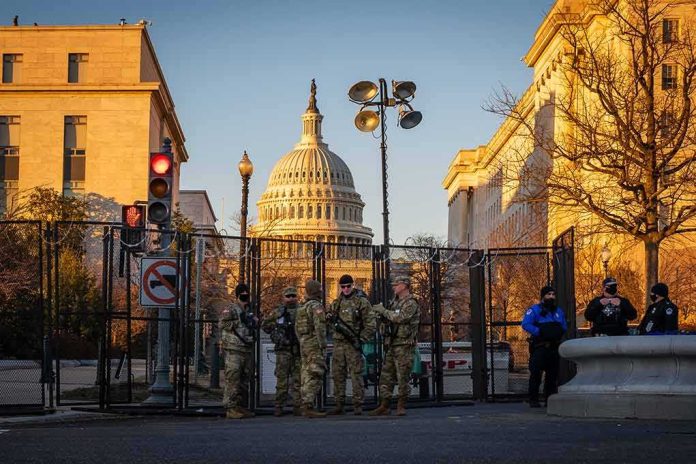 shutterstock_1898227372-1 National Guard troops stand at a security fence near the U.S. Capitol