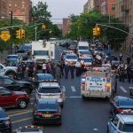 Trump Celebrates Biggest Violent Crime Drop in U.S. History Police vehicles and officers block a city street during an active scene