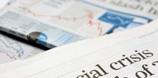 870,000 Suspect Borrowers Cut Off From New Federal Loans Close-up of a newspaper headline about a financial crisis