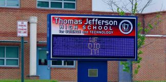 NYC Slams Brakes On Classroom AI Electronic school marquee in front of a brick high school
