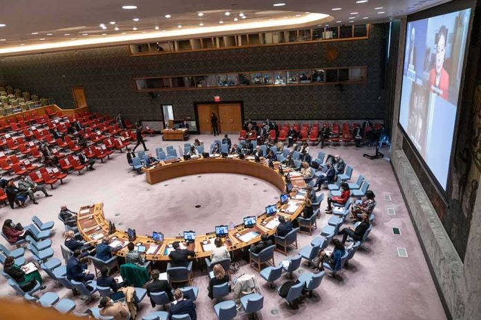shutterstock_2060521844-1 Delegates seated around a circular conference table in a large chamber