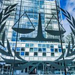 Cannabis Shell Scheme EXPOSED—Empire Under Fire! Scales of justice emblem on glass facade of modern office building