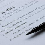 Bill document with pen on paper