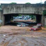 Killer Floods Pound West Virginia Flooded underpass with stranded cars in muddy water