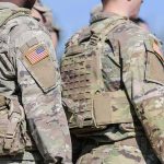 U.S. soldiers in camouflage uniforms with tactical vests