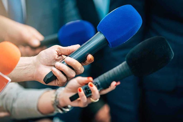 shutterstock_2168392339-4 Reporters holding colorful microphones