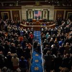 Legislative chamber audience stands and applauds