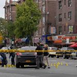 Festival Chaos: Gunman Vanishes Into Night Police investigate a taped-off urban street crime scene