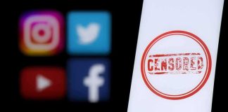 Smartphone screen with red censored stamp beside blurred social media icons