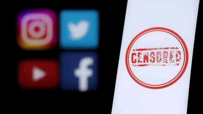 Smartphone screen with red censored stamp beside blurred social media icons