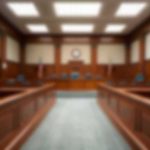 Empty courtroom with wooden benches and judge's bench