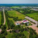 Robotic Bees Take Over Florida! Aerial view of rural landscape with roads, fields, and scattered buildings