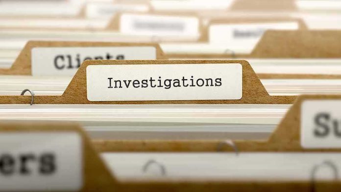 File folder tab labeled Investigations in a row of manila folders