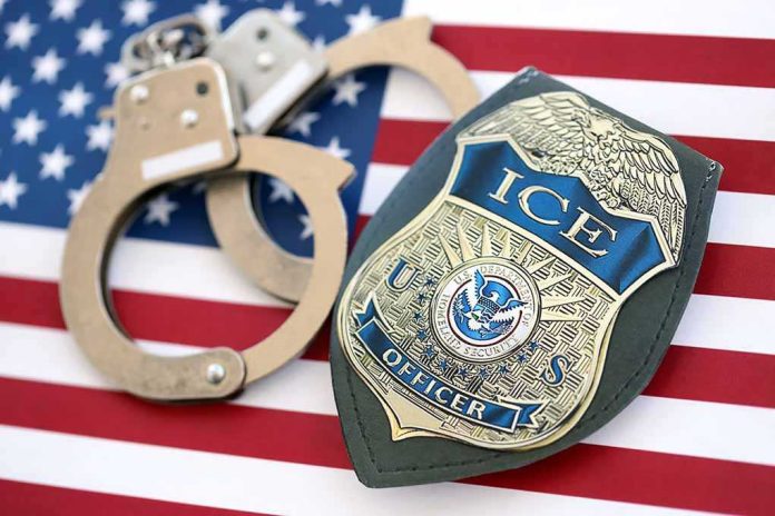 shutterstock_2782818537 ICE officer badge and handcuffs on an American flag