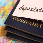 Influencer Hasan Piker’s Cuba Trip Catches Government Eye Stack of passports with a note labeled deportation on top, placed on a map