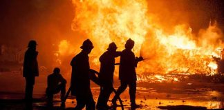 Firefighters battling a large blaze at night