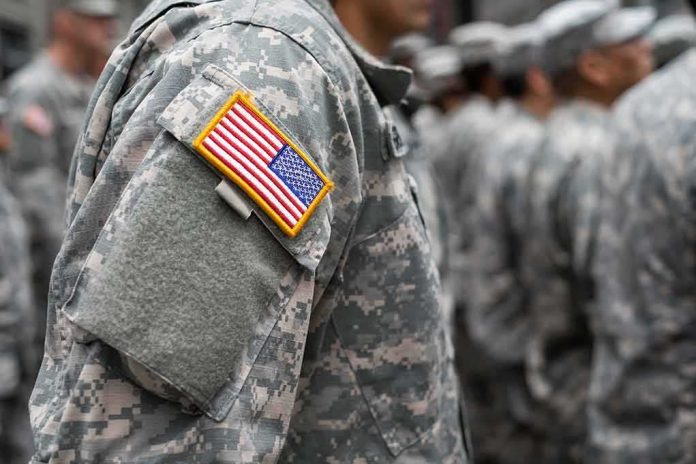 shutterstock_370106177 Soldier in camouflage uniform with U.S. flag patch