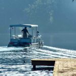 Lake Erie Nightmare: Child Vanishes, Arrest Follows Two people on a boat navigating a misty lake