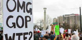 Karl Rove On WHY He’s Endorsing a Democratic candidate Protesters holding signs at a city street demonstration