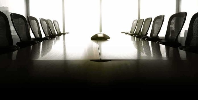 empty conference room with long table and chairs