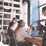162,000 Jobs SHATTER Expectations Coworkers collaborating at a desk in a modern office