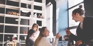 Coworkers collaborating at a desk in a modern office