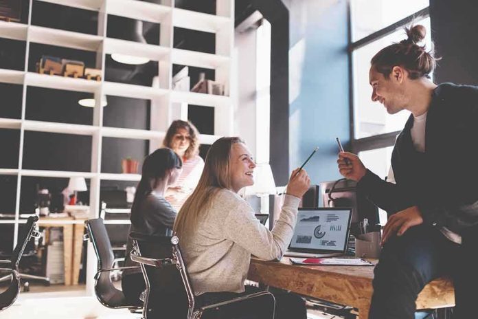 Coworkers collaborating at a desk in a modern office
