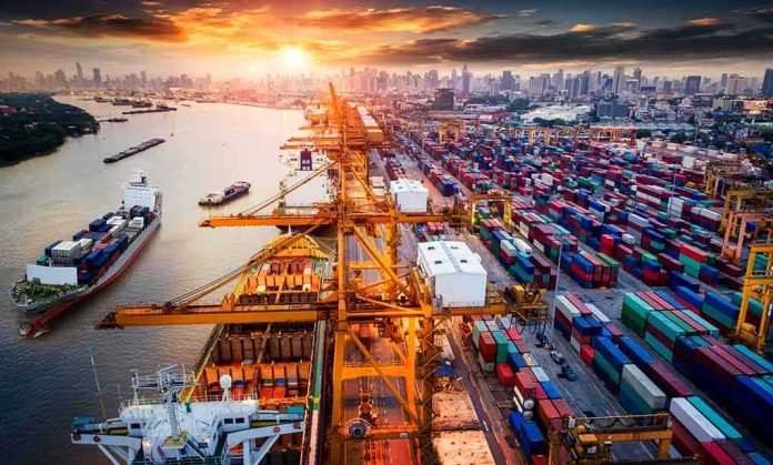 shutterstock_722794939 Container port with cranes and cargo ships at sunset