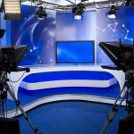 NBC Meltdown Over RNC Boss Hire A television studio setup with cameras and a blue backdrop