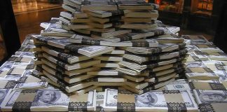 Feds Offer CASH for Fraud Tips Stacks of U.S. hundred-dollar bills arranged in a pyramid