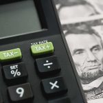 Democrats Accused of Killing No Tax on TIPS Calculator with tax buttons beside U.S. currency