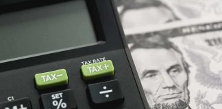 Calculator with tax buttons beside U.S. currency