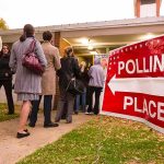 DOJ Gives State 48-Hour Ultimatum On Voter Roll Transparency Voters standing in line outside a polling place