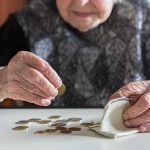 How Overseas SCAM Centers Target The Elderly Elderly person counting coins on a table