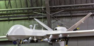 Ex-Google CEO Is Now Building ATTACK Drones military drone with missiles suspended in a hangar