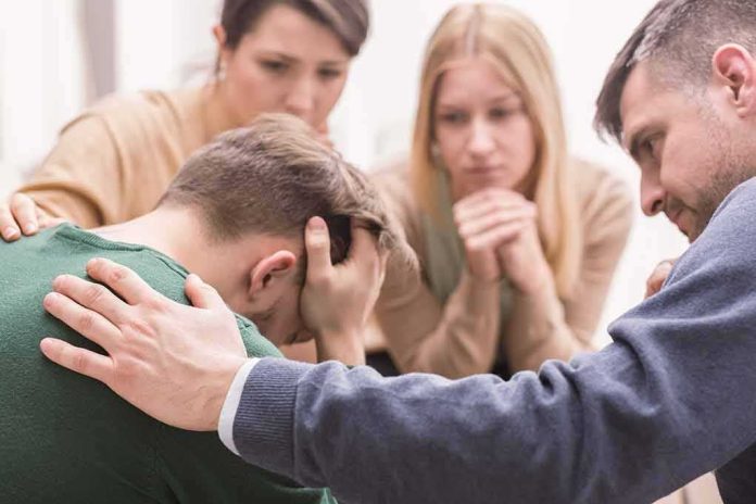 Man being comforted by friends