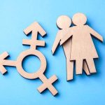 DAR EXPELS Chapter That Challenged Transgender Policy Wooden transgender symbol and two human figures on blue background